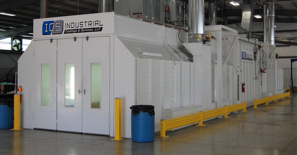 Large white industrial paint booths on the ICS shop floor